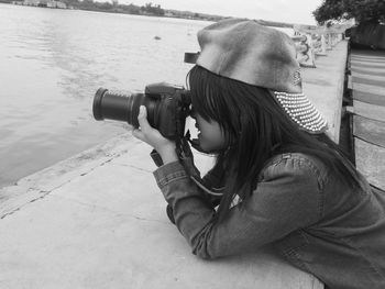 Rear view of woman photographing on camera