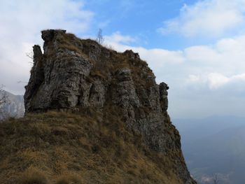 Low angle view of rock formation against sky