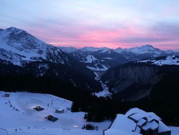 Scenic view of snowcapped mountains against sky during sunset