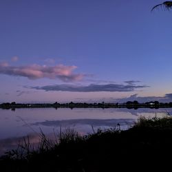 Scenic view of lake against sky at sunset