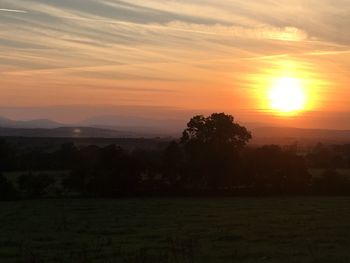 Scenic view of field against sky during sunset