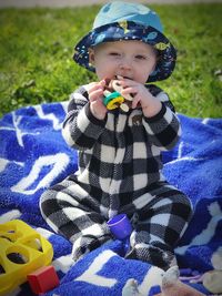 Portrait of boy playing with toy on grass