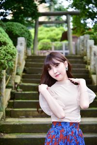 Young woman standing on staircase