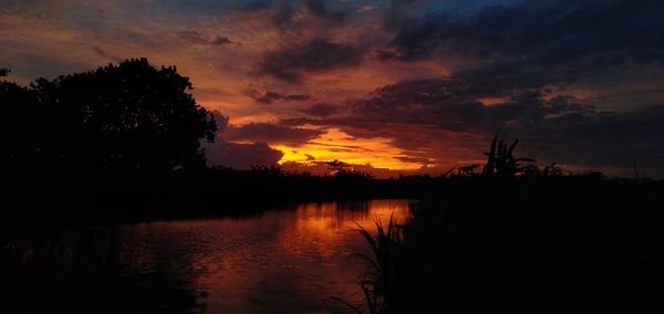 Scenic view of lake against orange sky