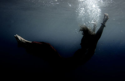 Full length of young woman undersea