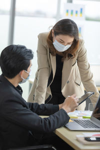 Business person wearing mask working at office