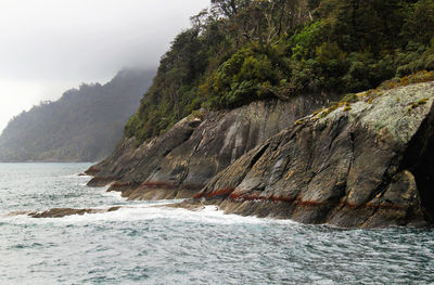 Scenic view of sea by mountain