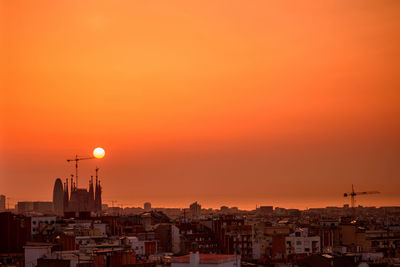 High angle view of townscape against orange sky