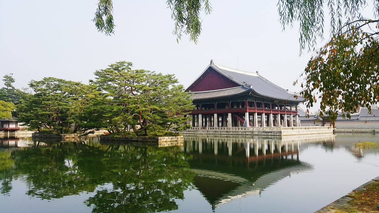 GAZEBO BY LAKE AGAINST SKY