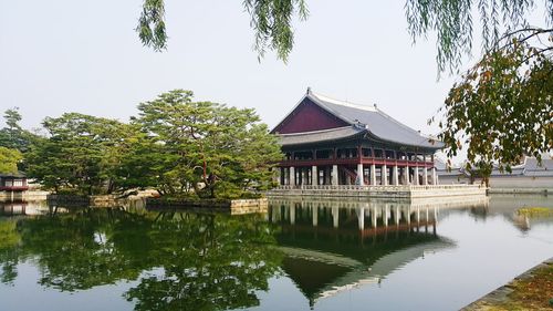 Gazebo by lake against clear sky