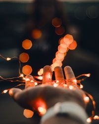 Close-up of hand holding illuminated lights