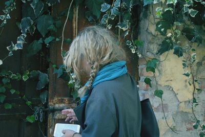 Close-up of girl standing against plants