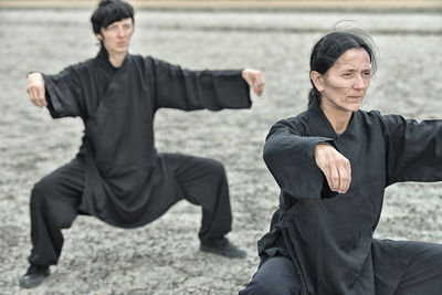 People practicing martial arts on land