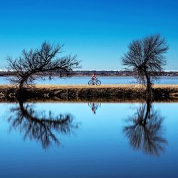 Scenic view of lake against clear blue sky