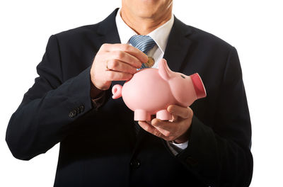 Midsection of man holding umbrella against white background