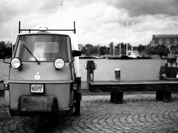 Rickshaw on pathway against cloudy sky