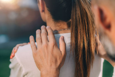 Reiki lesson. reiki instructor with hands over shoulders of the course attendee