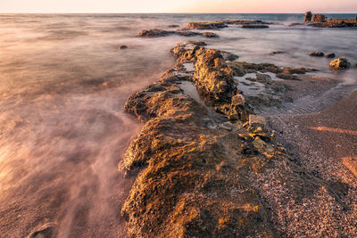 High angle view of rocks on beach against sky