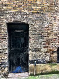 Close-up of door on brick wall