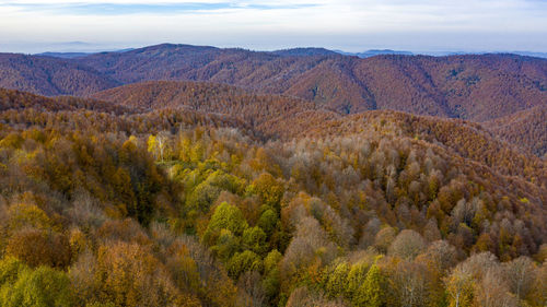 Scenic view of mountains against cloudy sky