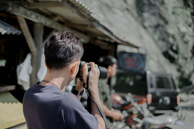 Man photographing in city