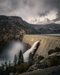 Aerial view of dam and mountains against sky