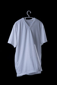 Midsection of man standing against black background