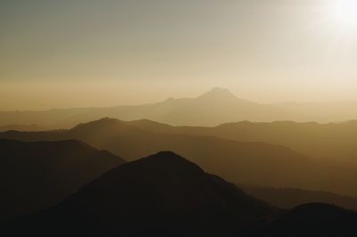 Scenic view of silhouette mountains against sky during sunset