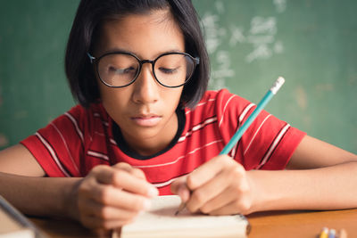 Portrait of woman with eyeglasses on table