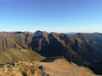 Scenic view of mountains against clear blue sky