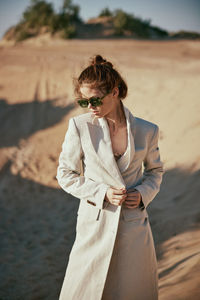 Young woman standing at beach