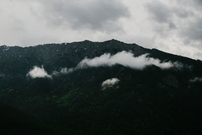 Scenic view of mountains against cloudy sky