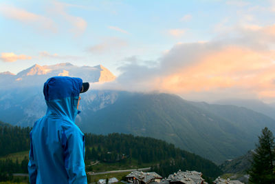 Man standing on mountain against sky