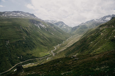 Scenic view of valley and mountains against sky