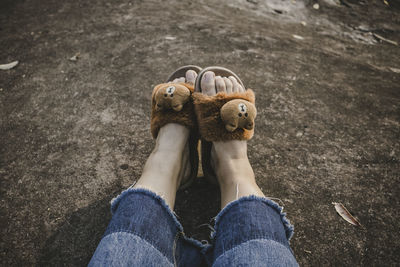 Low section of woman sitting outdoors