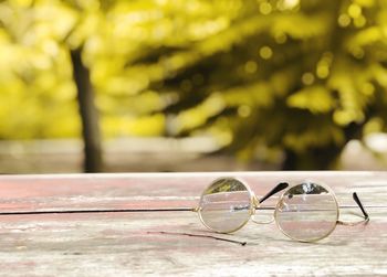 Close-up of sunglasses on glass table