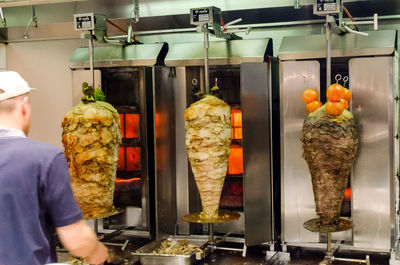 Rear view of a man preparing shawarma