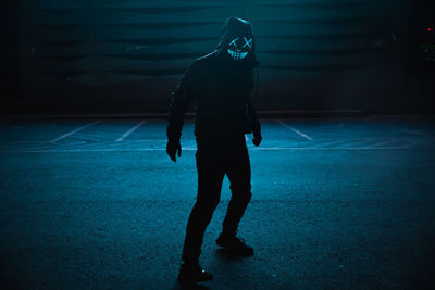 Full length of person walking on road at night