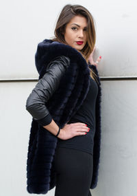 Portrait of beautiful woman standing in snow