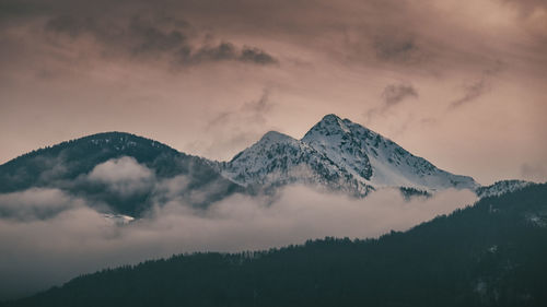 Low angle view of snowcapped mountains against sky during sunset