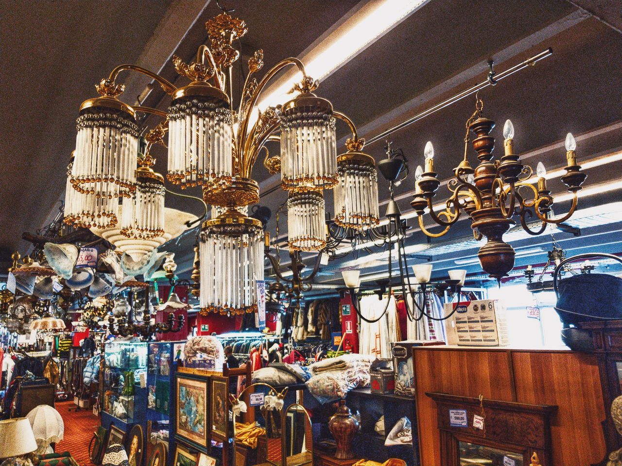 LOW ANGLE VIEW OF ILLUMINATED LANTERNS HANGING IN STORE