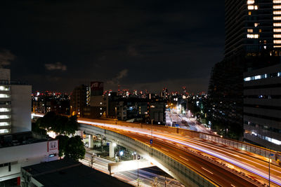 Light trails on road in city at night