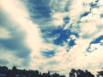 Low angle view of silhouette trees against sky