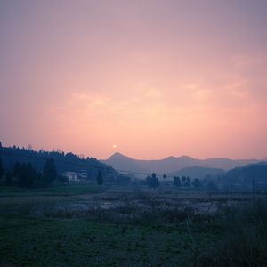 Scenic view of field against sky during sunset