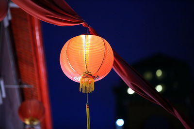 Low angle view of illuminated lanterns against sky