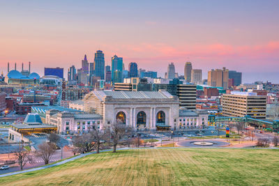 Buildings in city at sunset