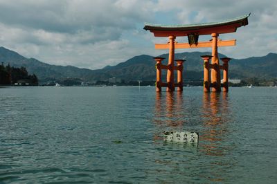 Torii gate at itsukushima shrine in sea