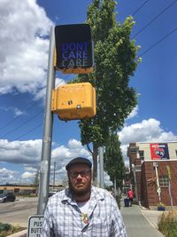 Man with text and plants against sky