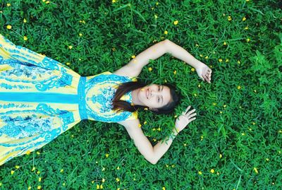 High angle view of woman lying on grass