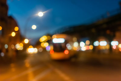 Defocused image of illuminated city street at night